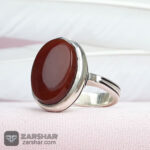 عکس انگشتر عقیق یمنی سرخ همراه حرز امام جواد(ع) و تربت